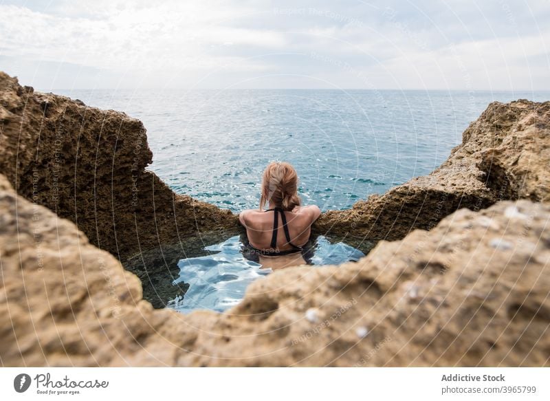 Woman at Algar seco natural caves pool in Algarve, Portugal woman sea admire vacation sunny travel algarve portugal swimming ocean idyllic rock stone tourism