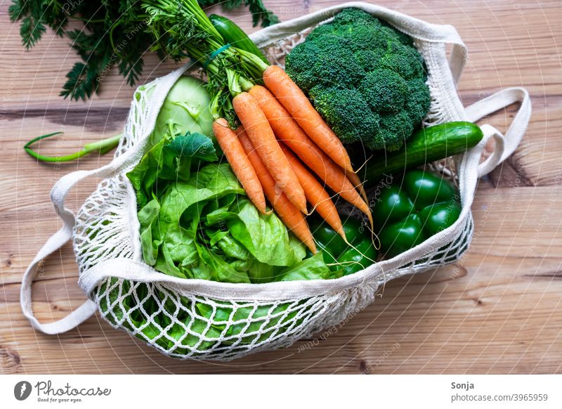 Fresh raw vegetables in a reusable shopping bag Vegetable Raw Carrot Lettuce Broccoli Diet Vegetarian diet Healthy regionally mesh pocket Shopping bag Reusable