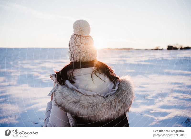 front, back and side view of young woman in winter clothes isola