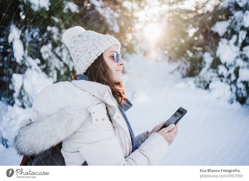 back view of woman in snowy mountain wearing modern coat at sunset. winter  season. nature - a Royalty Free Stock Photo from Photocase