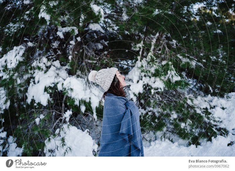 happy young woman hiking in snowy mountain wearing modern coat at sunset.  winter season. nature - a Royalty Free Stock Photo from Photocase