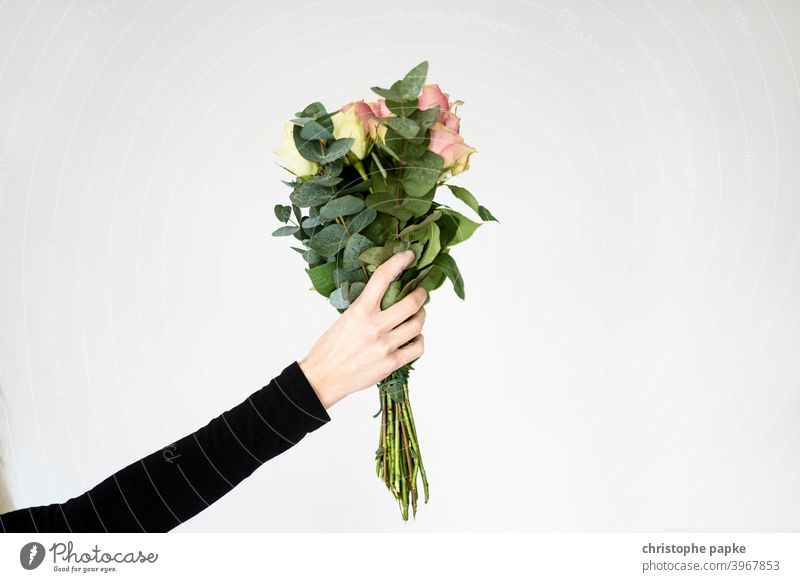 Man holding a bouquet of flowers - a Royalty Free Stock Photo from