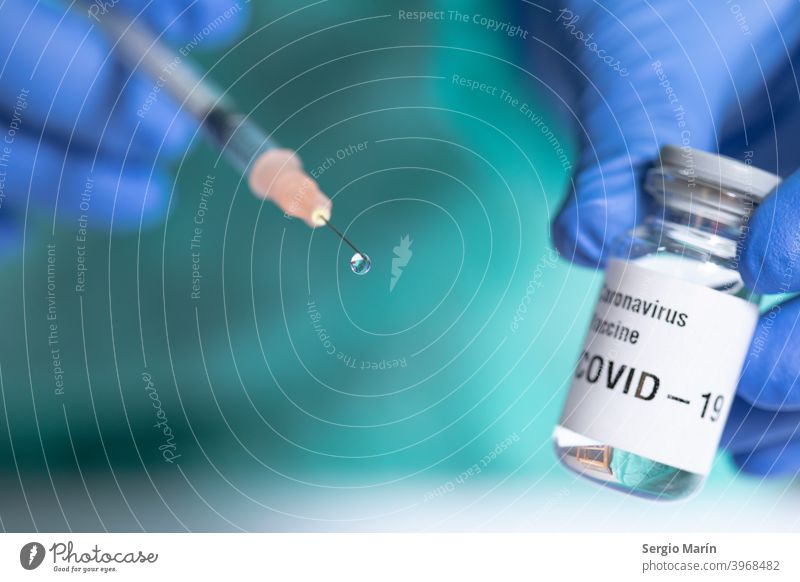 Close up of syringe with a vaccine drop. Focus on drop. coronavirus covid 19 treatment cure drug medication injection shot therapy clinical hospital 2019 2021