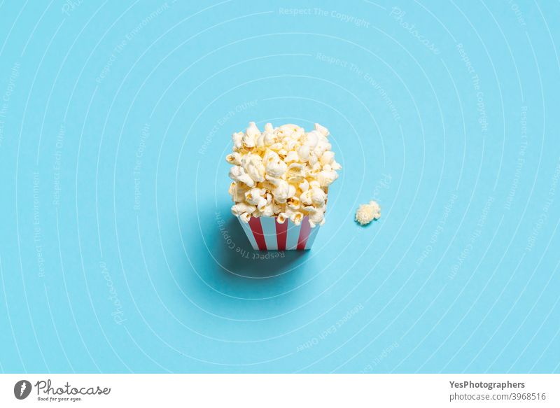 Popcorn box top view. Popcorn box isolated on a blue background. above view american appetizer bucket cardboard box cinema classic comfort food container