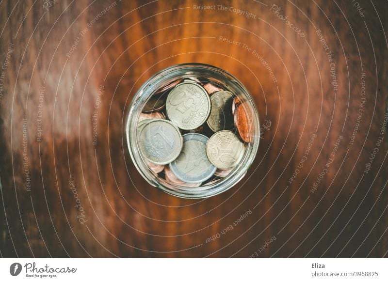 A jar full of saved coins. Coin Save Money Hand Bird's-eye view Glass Money box Euro Loose change Coins stop small livestock small change Wood safekeeping