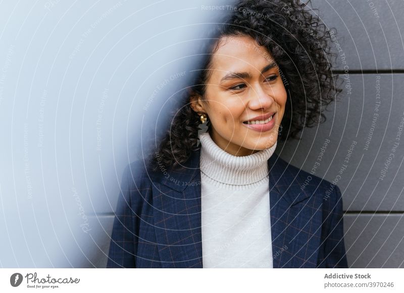 Confident ethnic businesswoman standing on the street confident self assured style trendy fashion young personality modern appearance millennial female pensive