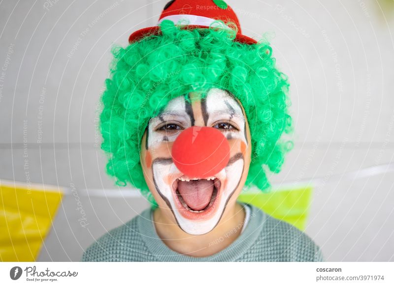 Little boy celebrating carnival at home dressed as a clown 1 april background birthday celebration cheerful child childhood close up colorful concept costume