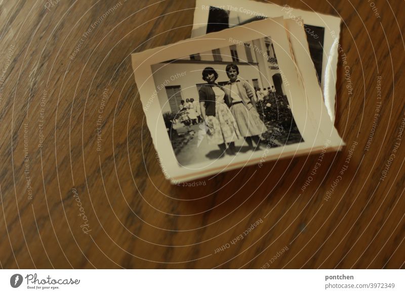 Old photos in black and white on wooden background. Time travel, past, found objects black-white 50s vintage Memory Black & white photo Nostalgia Photography