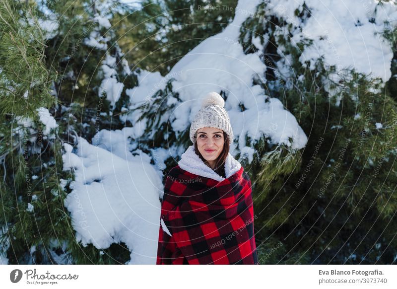 happy woman hiking outdoors in snowy mountain. Wrapped in plaid blanket. Nature and lifestyle wrapped relax caucasian sunny enjoy travel wanderlust backpack