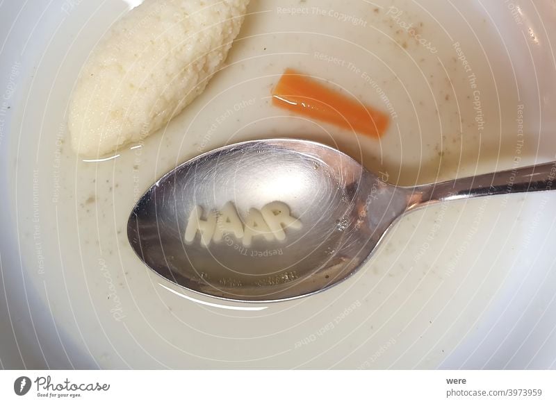 spoon with letters soup noodles in a white soup plate next to semolina gnocchi and carrot german text hair German text Spoon Stock Carrot clear soup disruptive