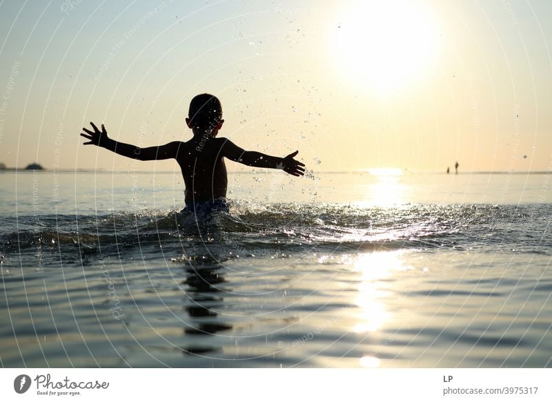 happy child in the ocean at sunset dancing Faith & Religion background Forward Arm Hand Contentment Dance Posture Vacation & Travel Twilight summer fun people