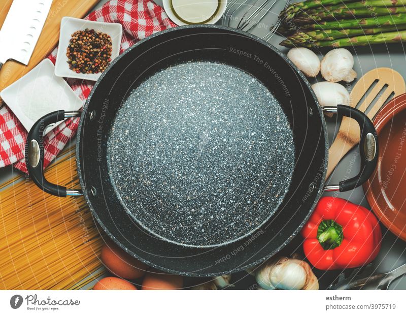 https://www.photocase.com/photos/3975719-top-view-of-empty-frying-pan-with-ingredients-for-cooking-photocase-stock-photo-large.jpeg