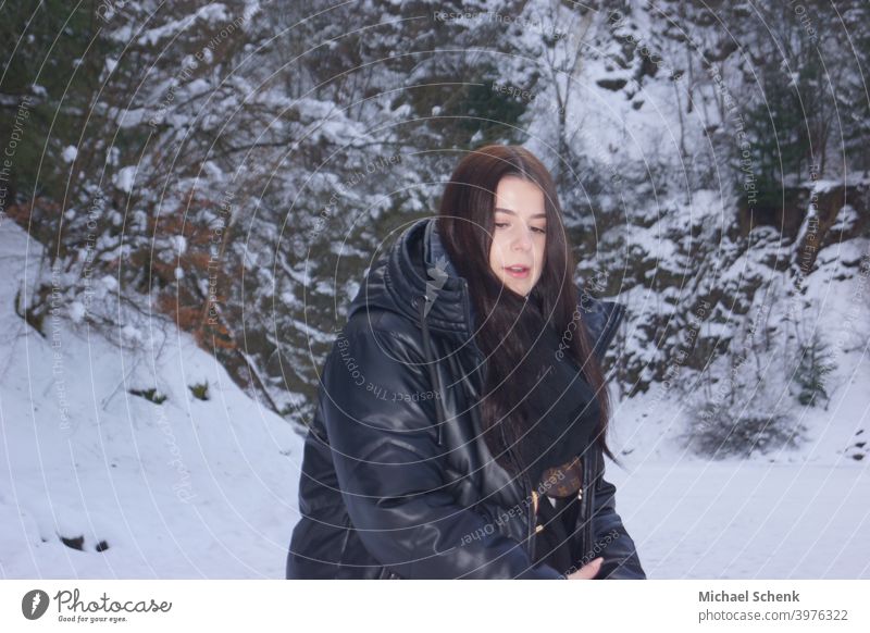 Young woman with long black hair in snow Woman 18 - 30 years Adults Nature Landscape Long-haired naturally Exterior shot Day portrait Snow Hair and hairstyles