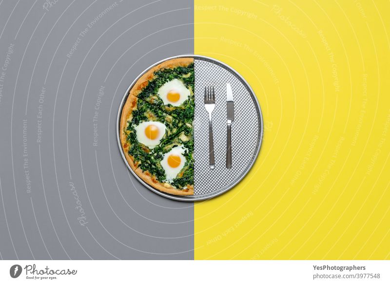 Vegetarian pizza with egg and spinach, top view. Half pizza isolated on grey and yellow color Italian cheese color of the year colored background