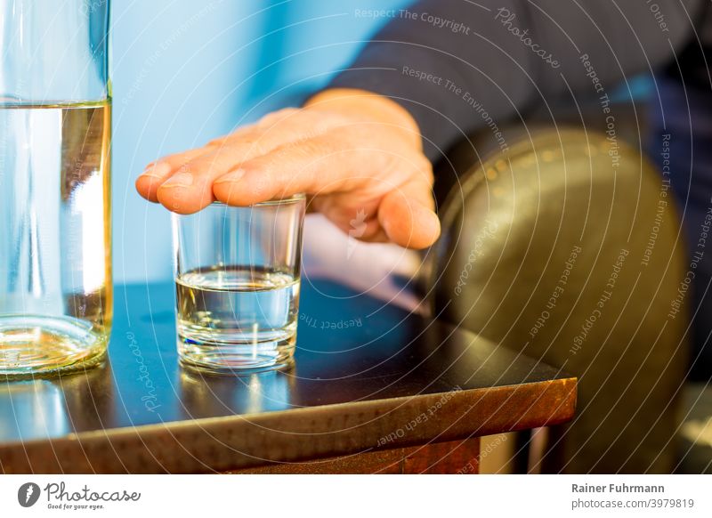 A man put his hand on a glass, he doesn't want to drink. Close-up Glass Beverage Hand Alcoholic drinks booze Drinking Bar Table Party Night life Club Lifestyle