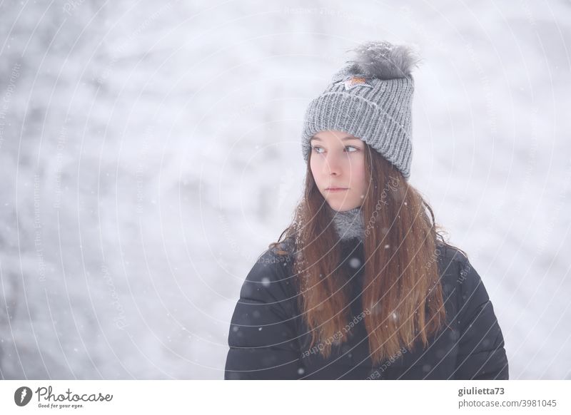 Teenage girl with melancholic look outside in snowy winter forest portrait Girl teenager Youth (Young adults) Colour photo Exterior shot Cap winter jacket