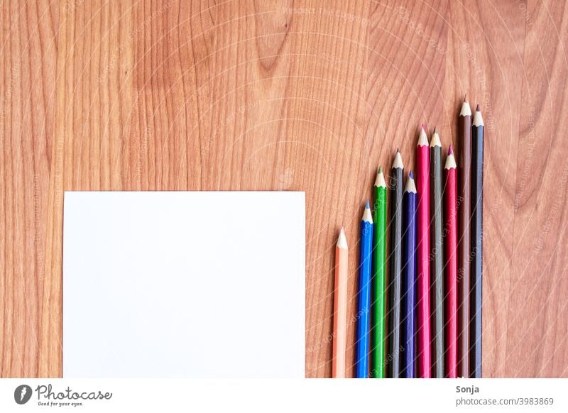 Crayons and a blank sheet of paper on a wooden table crayons Paper Empty Creativity Stationery Colour photo Piece of paper Draw Leisure and hobbies