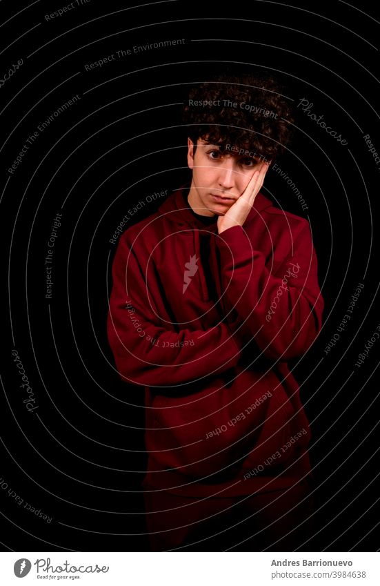 Attractive young man with curly hair posing on black studio background caucasian closeup thoughtful guy looking people short attractive beauty haircut fashion