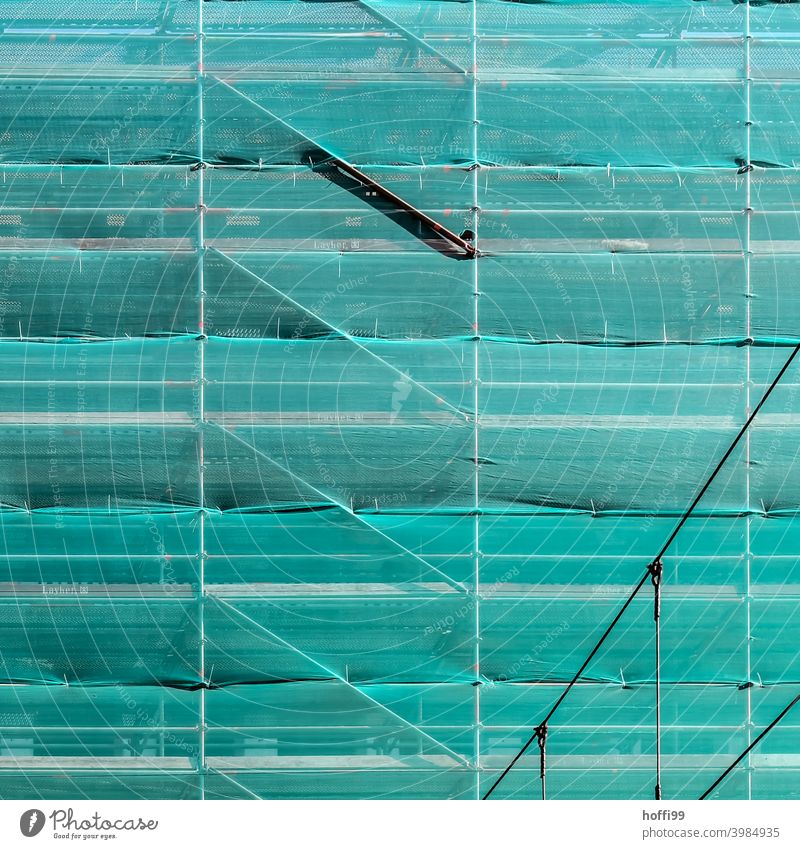 green safety net in front of a scaffolded facade Green Net Construction site Scaffolding scaffold tarpaulin Facade Structures and shapes Redecorate