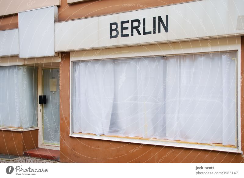 secluded shop through white curtains with the inscription Berlin Berlin-Wedding Store premises Storefront overcast Front door discreet Folds opaque Lettering
