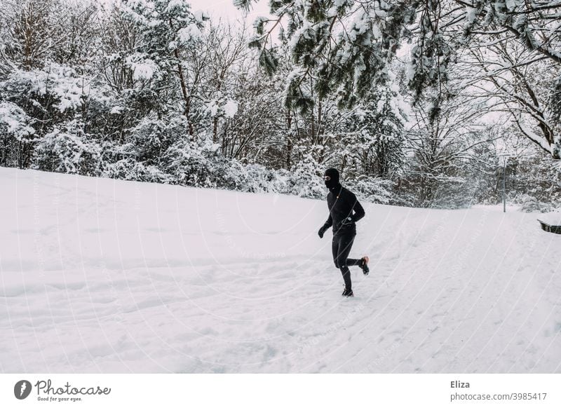 A man jogs through the snow in winter Snow Jogging Walking Sports Winter Man Fitness Movement Athletic Park Nature Snowscape Runner workout Jogger