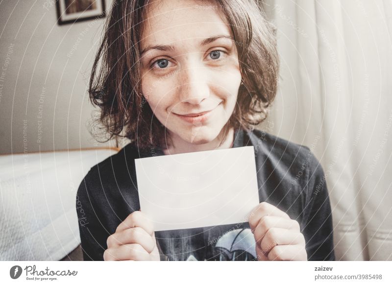 Girl Smiles While Holding A Paper With Her Hands A Royalty Free Stock