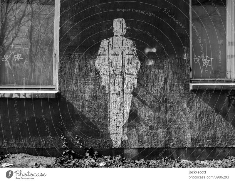 Figure of a person replaced by a plaster facade shape Posture Street art Subculture Lifestyle Style Creativity Silhouette Hat Wall (building) Imprint