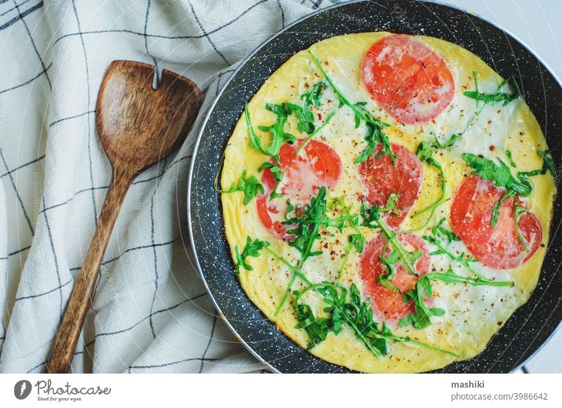 tasty italian style vegetarian breakfast - fried eggs frittata ot omelete with mozarella cheese, arugula and tomatoes vegetable food healthy lunch closeup