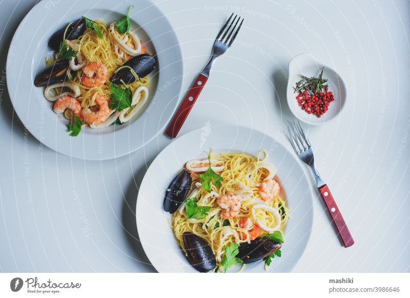 tasty gourmet spicy seafood pasta with shrimps, squid and mussels cooked with pink pepper and thyme spaghetti plate meal dinner lunch noodle dish healthy tomato