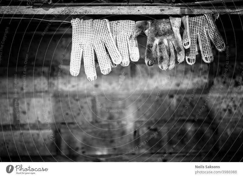 dirty work gloves drying on wire / brick stone background Accessory assistance bright brightly clean closeup clothing concepts copy day dual gray green grey