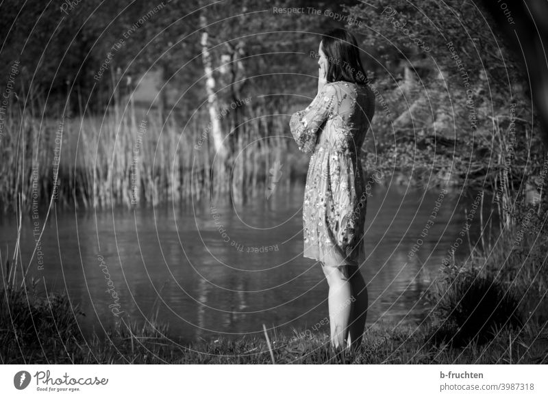 Woman in summer dress standing by the stream ponder Black & white photo Brook Body of water Think Face Looking Thought Grief Calm Hand Sadness waiting Wait Fear