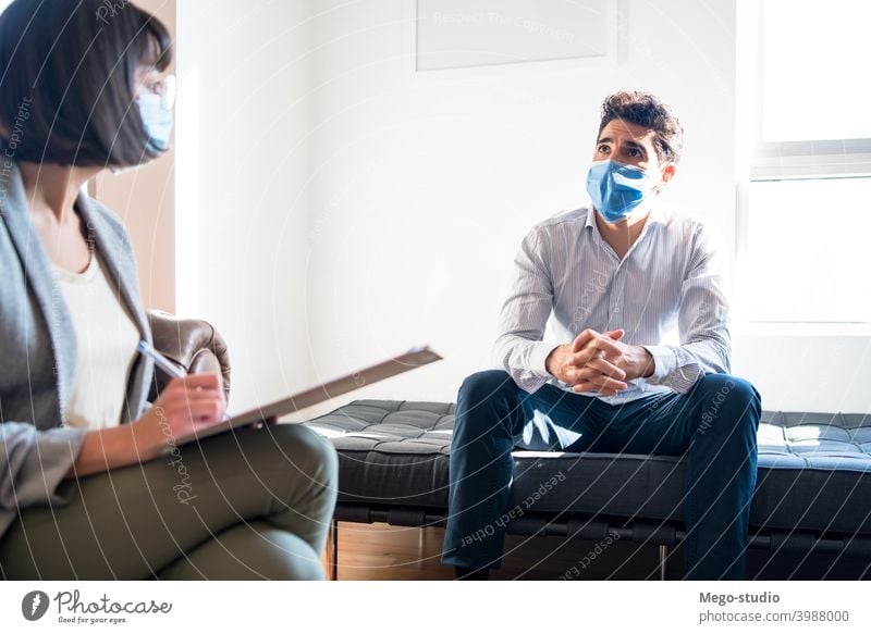 Psychologist talking with patient on therapy session. psychologist professional notes mental health face mask therapist psychotherapy psychology doctor