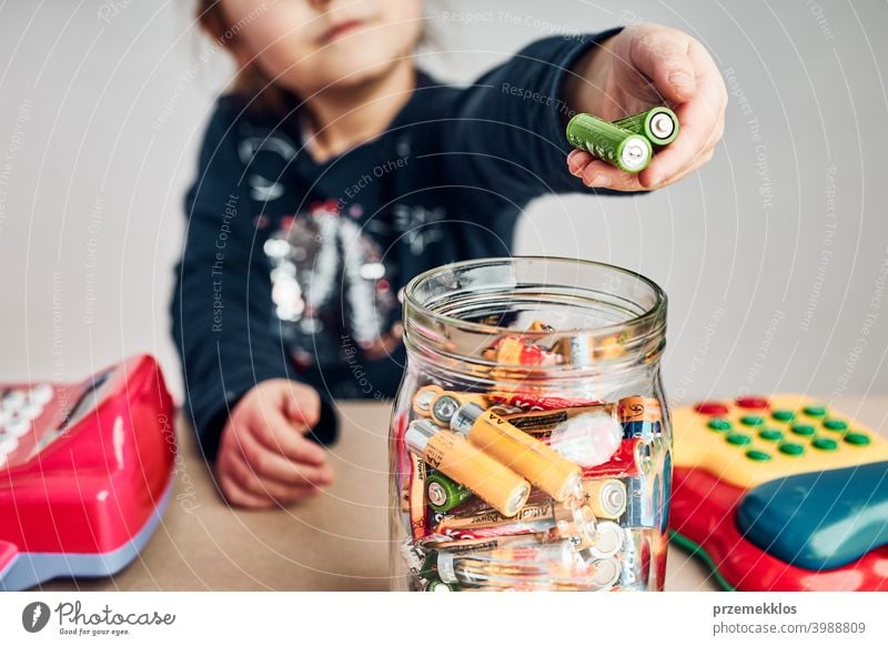 https://www.photocase.com/photos/3988809-little-girl-putting-used-batteries-into-jar-for-recycling-child-separating-waste-photocase-stock-photo-large.jpeg