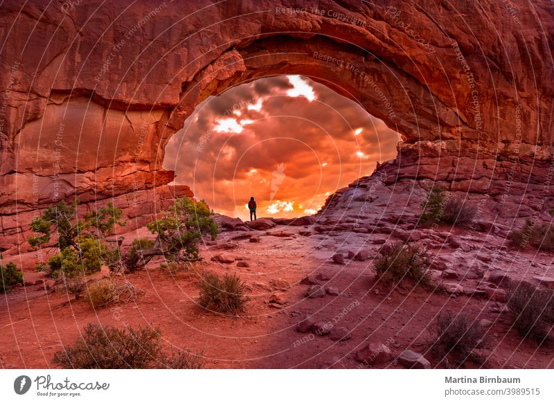 Enjoying the sunrise in the North Window Arch, Arches National Park Utah usa arch north window arches national park tourist tourism people moab utah landscape