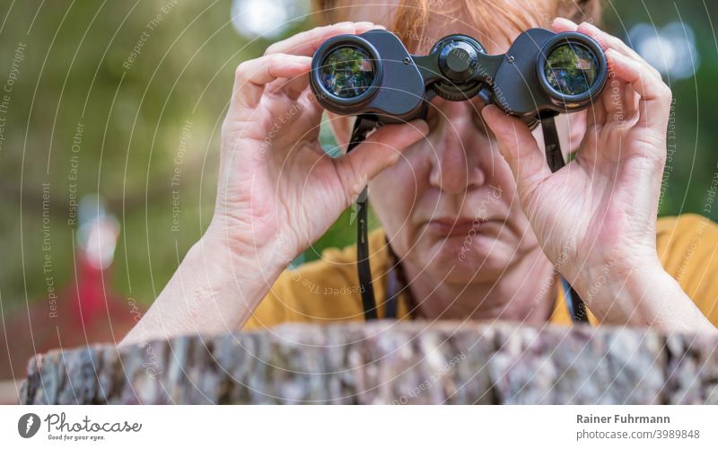 Close up of woman looking through binoculars in disappointment Close-up Woman Binoculars Colour photo Exterior shot Observe Looking Day Human being Adults