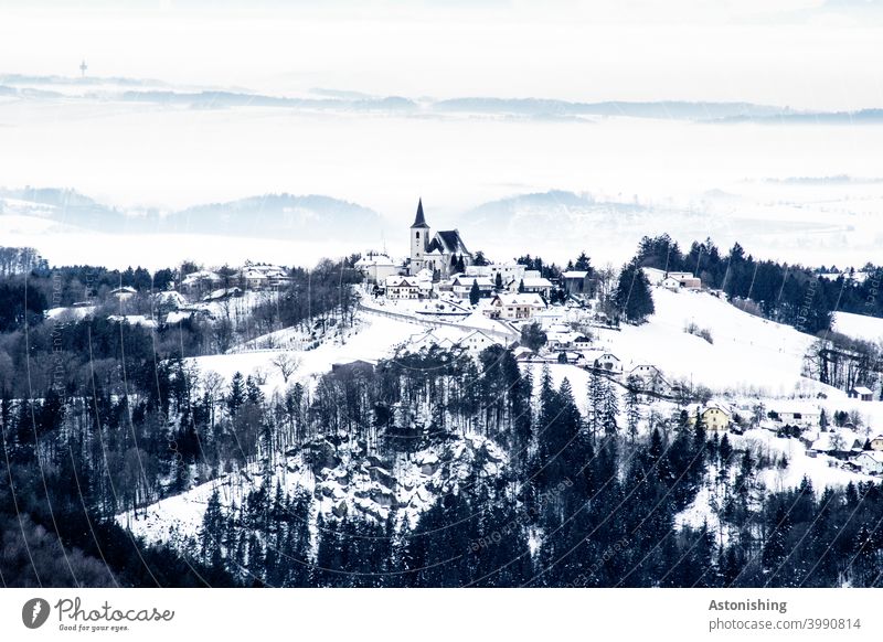 small, snow-covered village in a hilly landscape All Saints' Day in the Mühlkreis Landscape Nature location Village Church Church spire Austria mill district