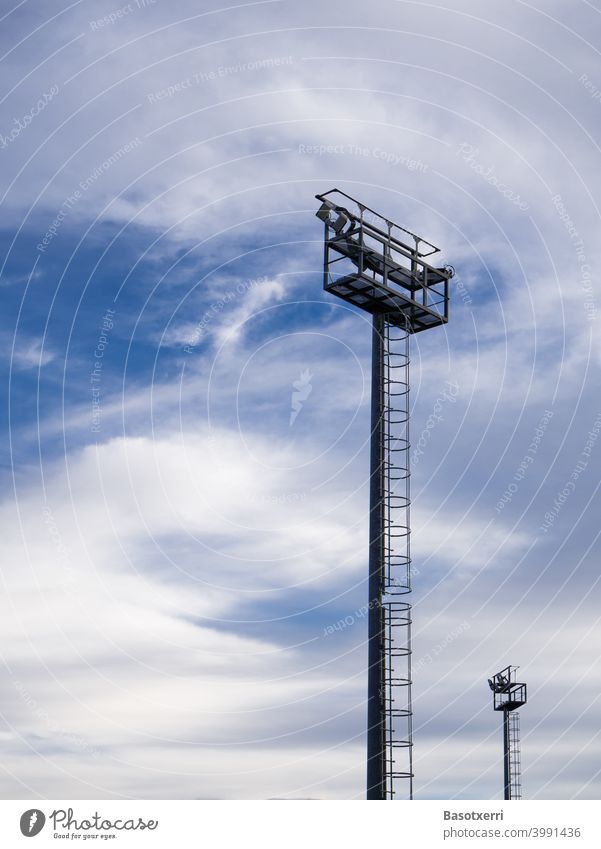 Lighting poles on the field in front of interesting sky Abstract Pole Colour photo Sky Deserted Day Blue Exterior shot Copy Space top Copy Space left Lamp