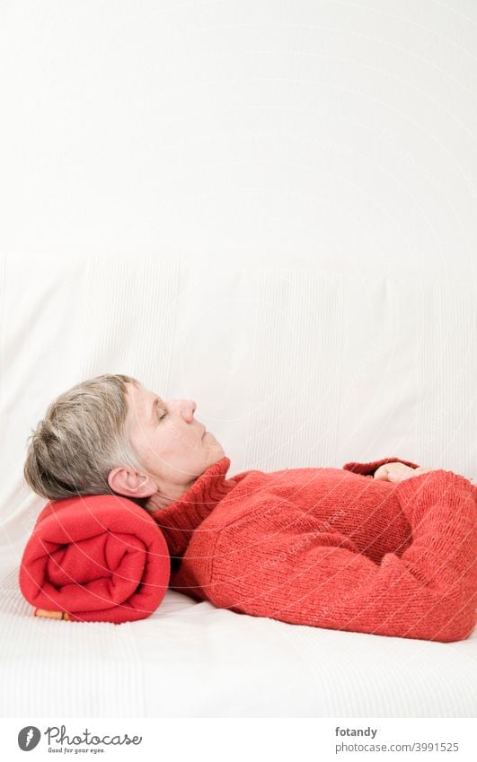 Relaxation in red vertical relax Woman Upper body older woman Satisfaction Adult peaceful Gray hair short hair cozy feel well lying on your back Person