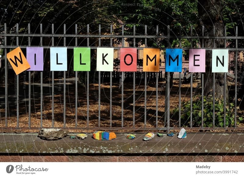 Lettering WELCOME made of black letters on coloured paper on the fence of a school after the summer holidays in the Nordend district of Frankfurt am Main in the German state of Hesse