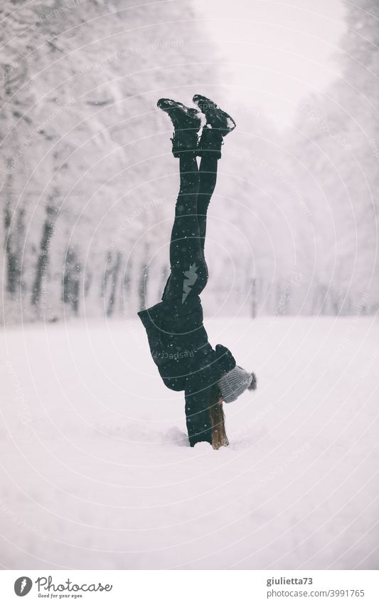 Sporty young woman in snowy park does handstand in the snow Winter Sports Snow Playing Exterior shot Joy White Cold Happy Infancy Seasons Vacation & Travel