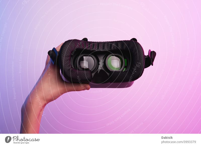 Virtual reality glasses in hand on colorful background. Future technology, VR concept vr headset virtual white helmet device game future video experience