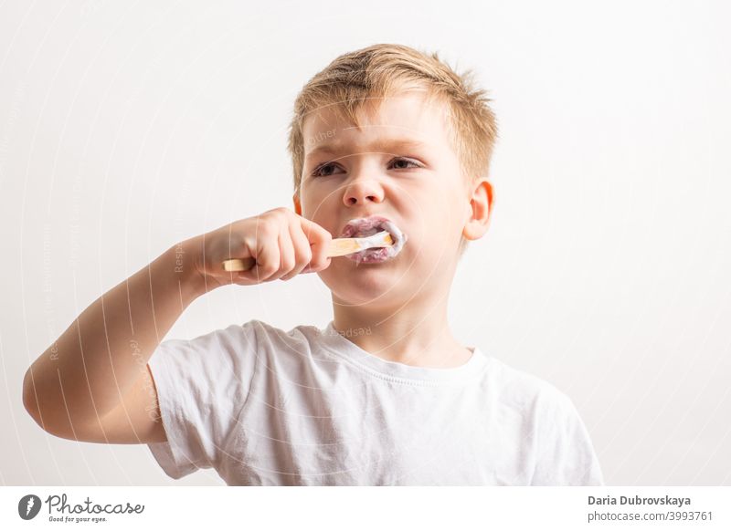 boy brushing teeth with a bamboo toothbrush healthy lifestyle portrait childhood cute kid young care dental smile happy caucasian oral toothpaste mouth face