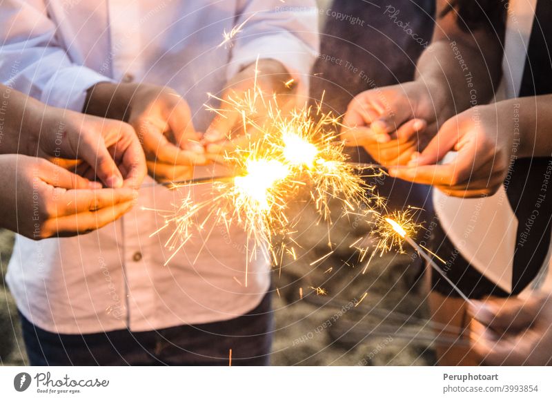 Beautiful sparklers in people hands, xmas and new year concept. light background celebration evening holding night fireworks abstract beautiful birthday