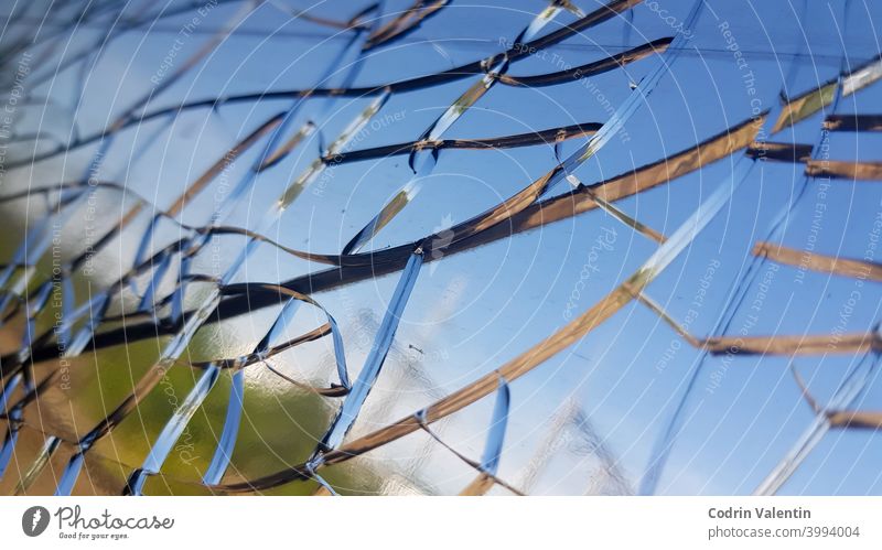 Closeup shot of the cracks on the glass of a window abstract blue sky blur broken crash damage design impact landscape light nature no person outdoor outdoors