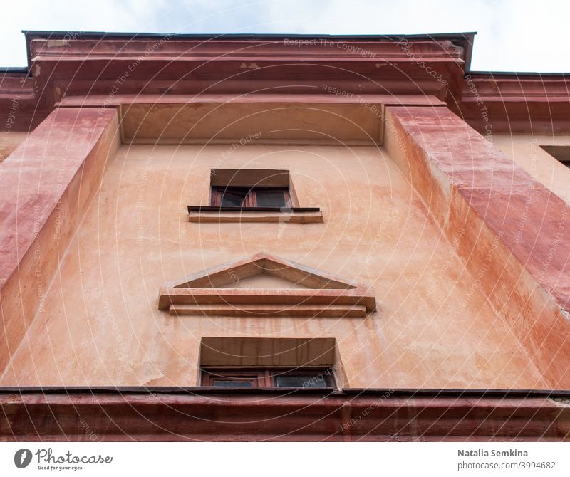 Close-up part of old building with small windows. Lower angle shot. architecture background close-up culture day detail dilapidated exterior front home house