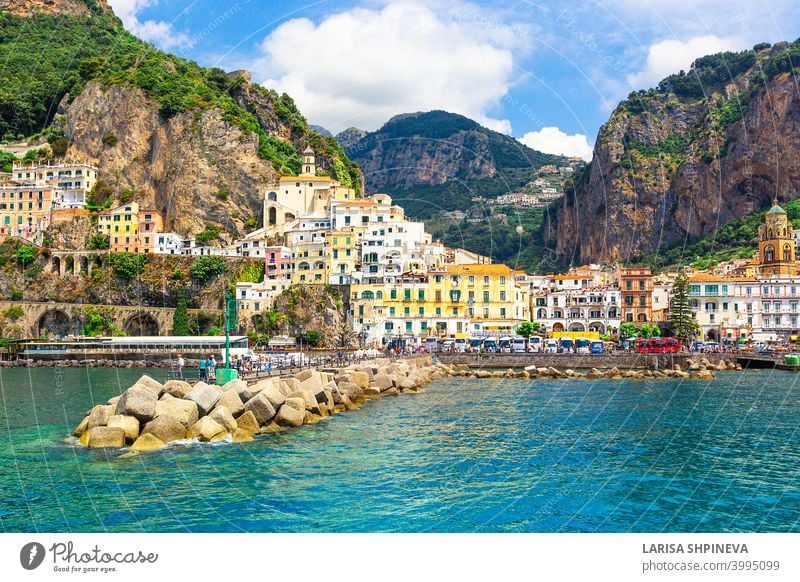 Panoramic view, aerial skyline of small haven of Amalfi village with tiny beach and colorful houses located on rock. Tops of mountains on Amalfi coast, Salerno, Campania, Italy