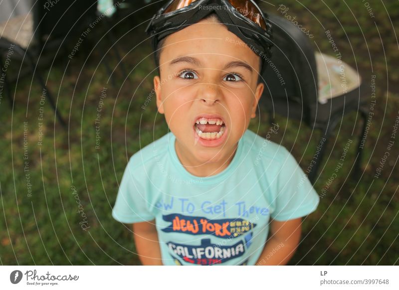 Angry child showing teeth at the camera Looking into the camera Front view Upper body Portrait photograph Dentist Teeth Self-confident Euphoria Anticipation