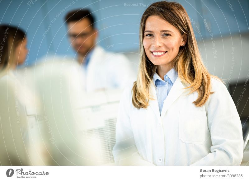Female scientist in white lab coat standing in the biomedical lab female woman research professional worker biology science technician biotechnology physician