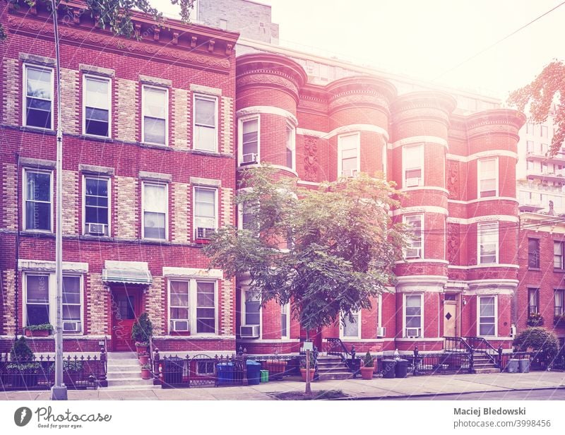 Retro toned picture of townhouses in Brooklyn New York, USA. street city building apartment retro vintage window neighborhood filtered pavement sidewalk empty