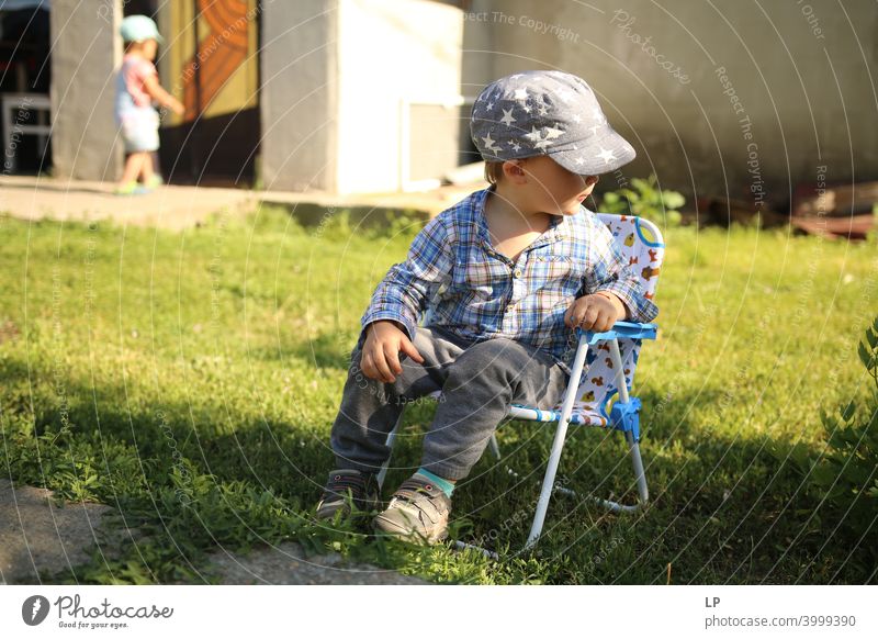 happy child resting and sitting down on a chair looking away Relaxation Communication Body language amusing Entertainment Childhood memory real people growth